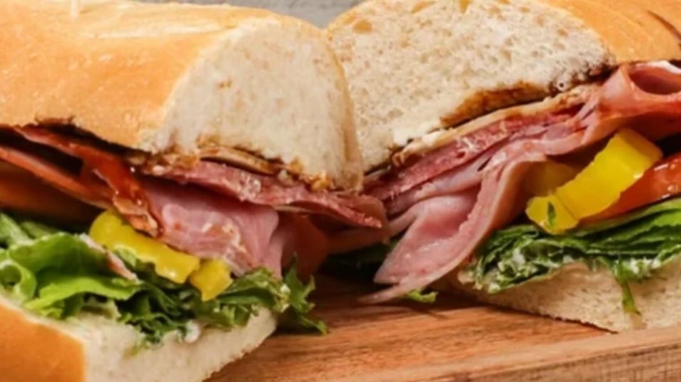 The Sphere sandwich cut in half, showing layers of ham, salami and prosciutto with provolone